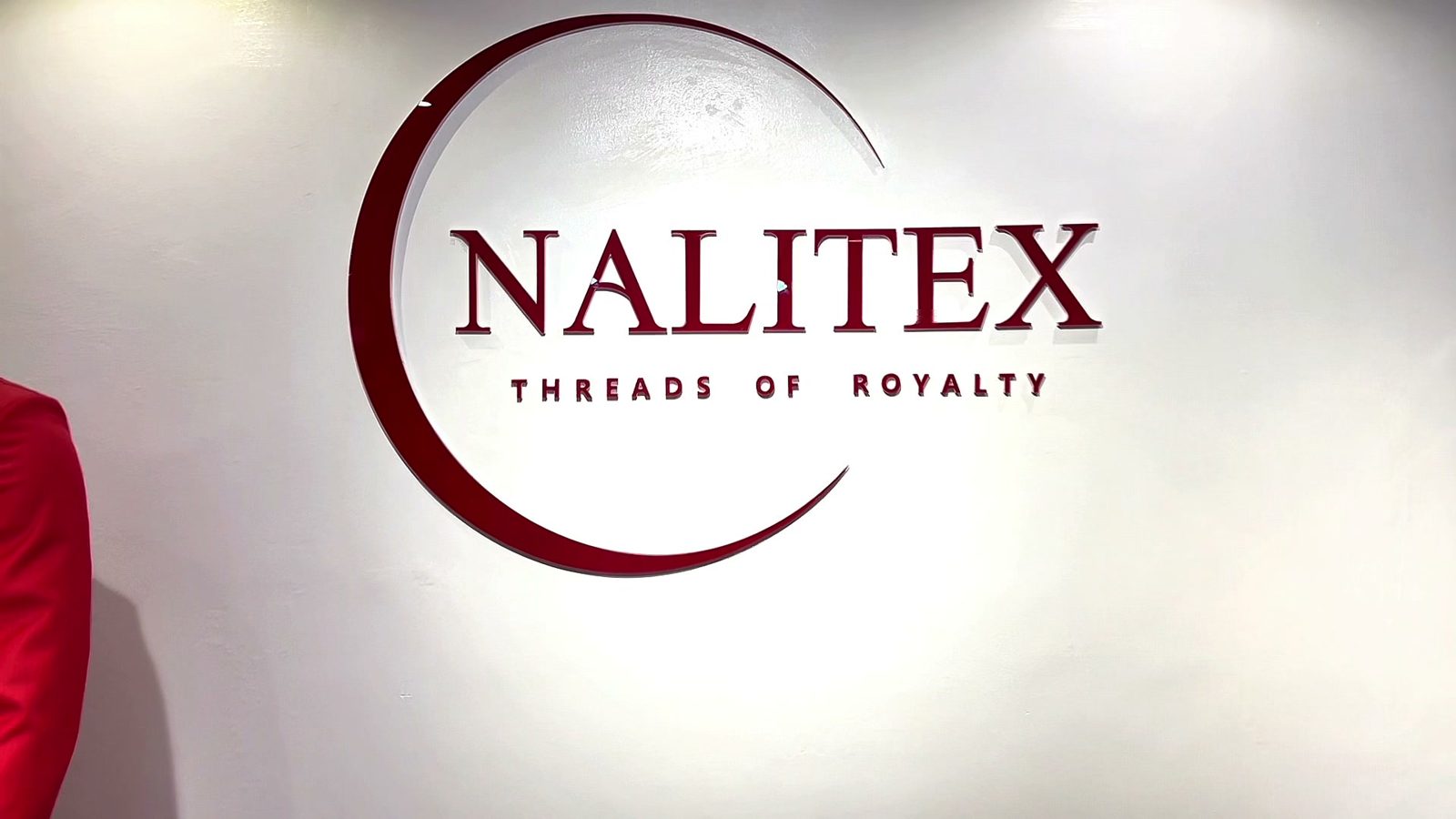The Nalitex logo, Threads of Royalty, on the showroom wall